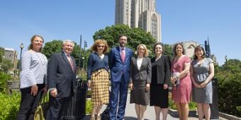 Group posing with the Cathedral of Learning in the background